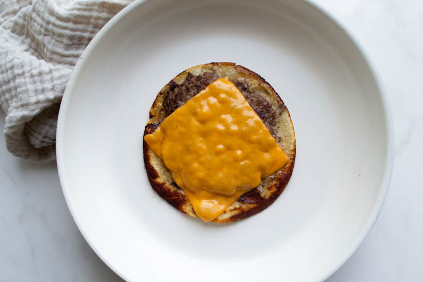 Smash burger taco topped with cheese