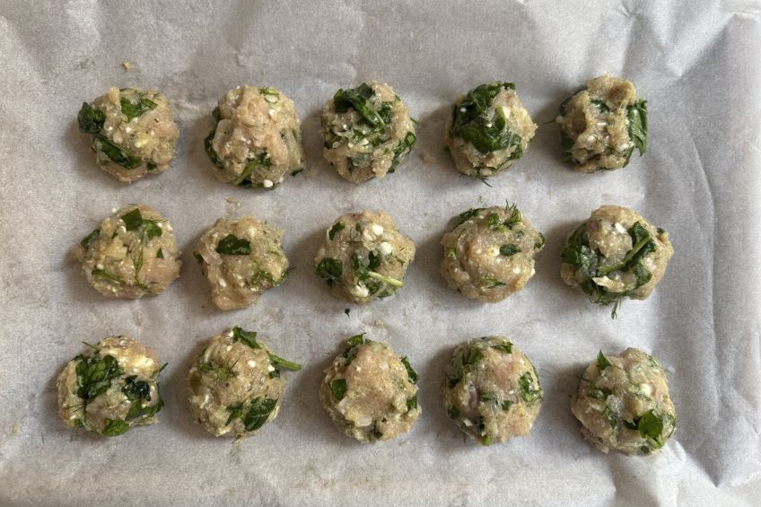 spinach feta meatballs on baking tray